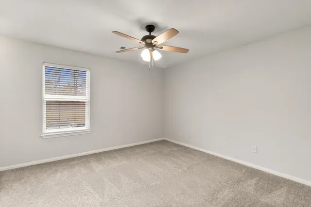 a view of an empty room with a ceiling fan