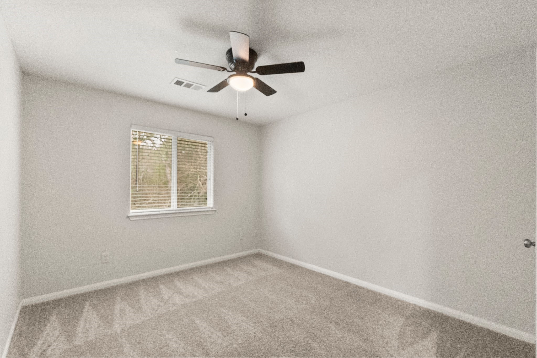 1799 League Line Road, Unit 4 Conroe, TX 77304 - Photo 31 of 34 an empty room with windows and fan