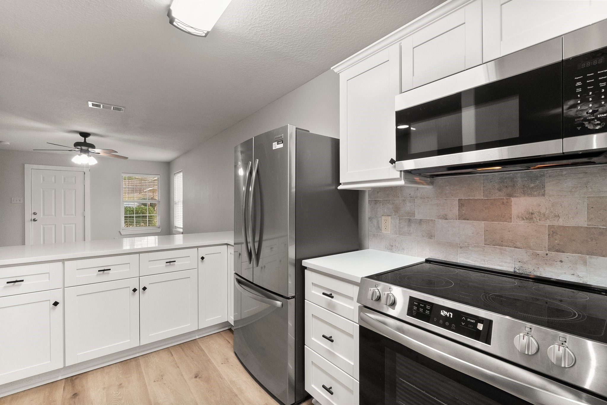 1799 League Line Road, Unit 4 Conroe, TX 77304 - Photo 8 of 34 a kitchen with granite countertop cabinets and steel stainless steel appliances