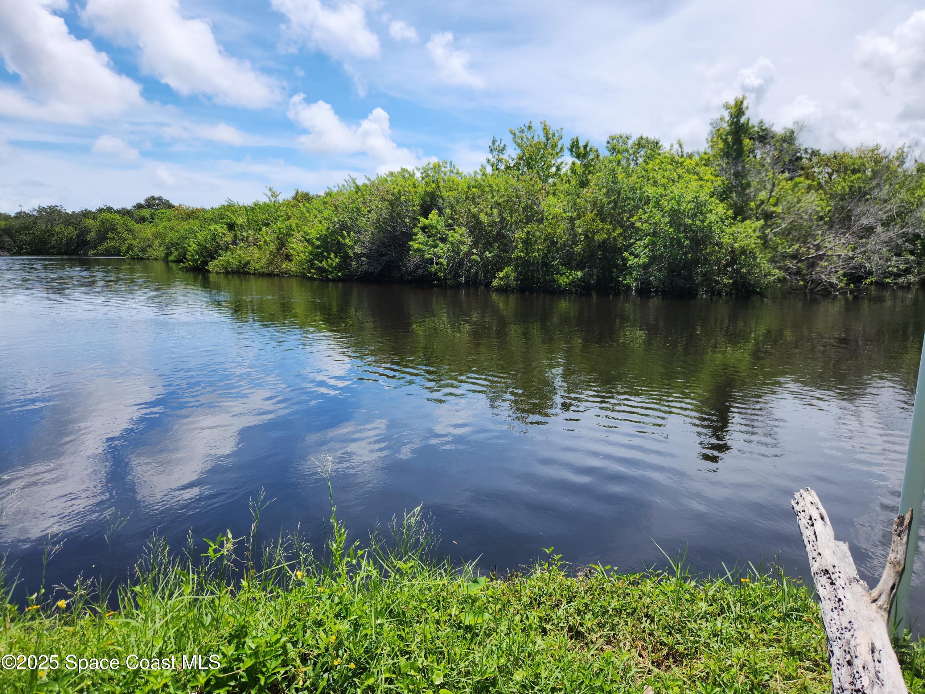 409 Roxy Avenue Melbourne, FL 32901 - Photo 2 of 4 a view of a lake with a yard