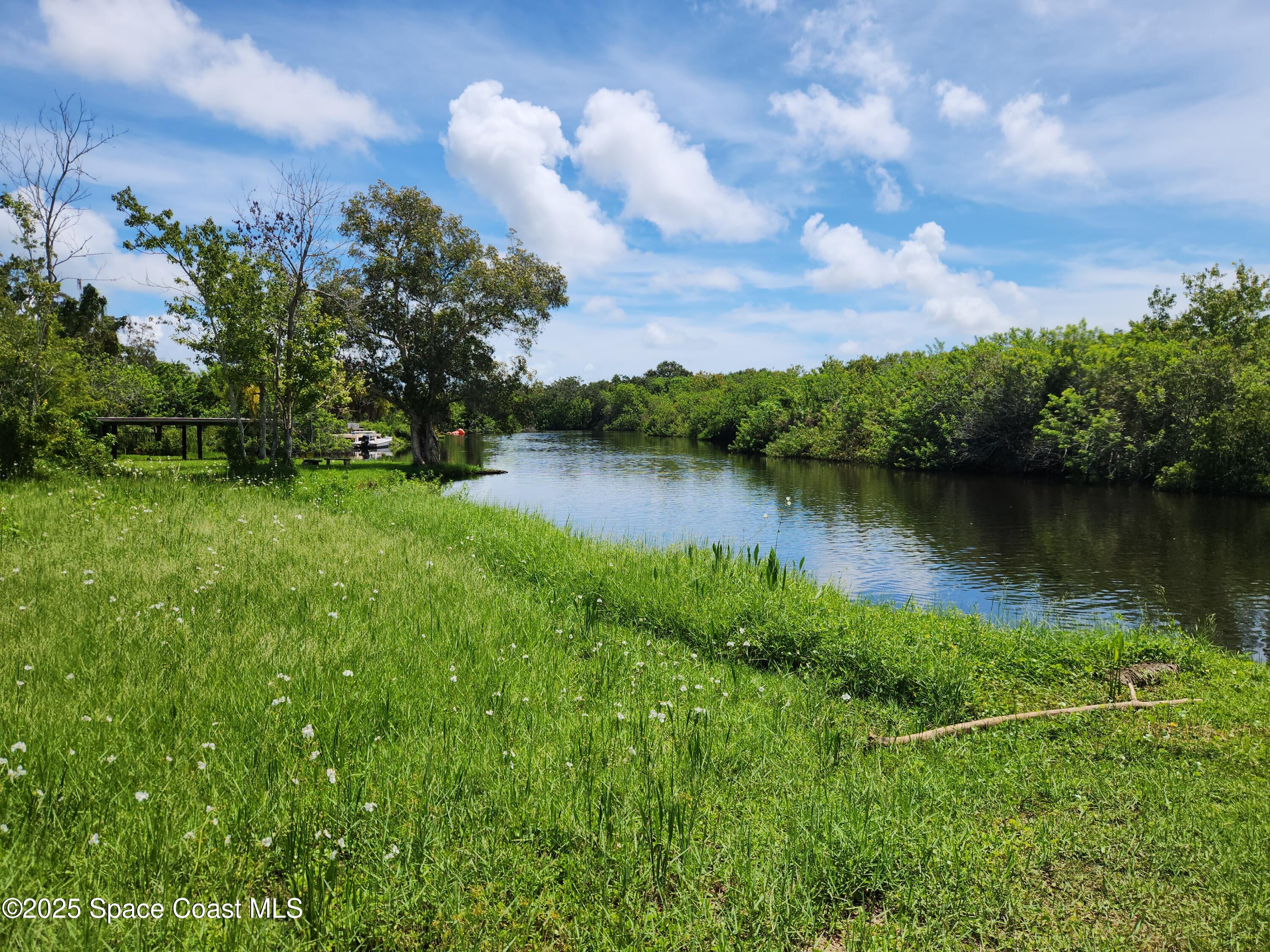 409 Roxy Avenue Melbourne, FL 32901 - Photo 3 of 4 a view of a lake with houses in back