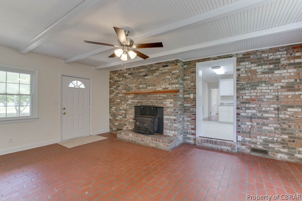 400 Showalter Road Yorktown, VA 23692 - Photo 23 of 49 Unfurnished living room with brick wall, ceiling fan, and beam ceiling