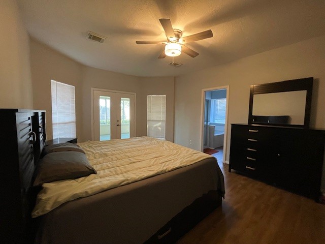 2202 Melanie Park Drive Spring, TX 77388 - Photo 16 of 21 a bedroom with a bed and a flat tv screen on dresser
