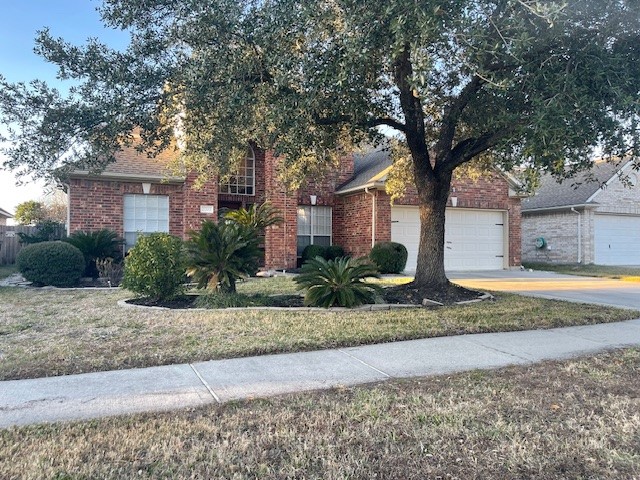 2202 Melanie Park Drive Spring, TX 77388 - Photo 2 of 21 a front view of a house with a yard and garage