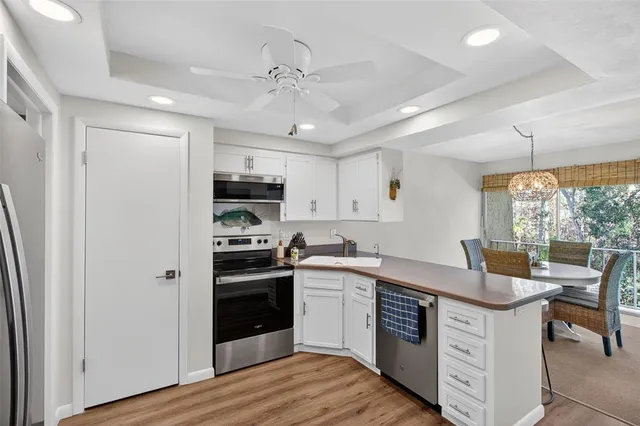 a kitchen with stainless steel appliances granite countertop a stove and a refrigerator