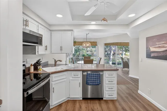 a kitchen with stainless steel appliances granite countertop a stove and a sink