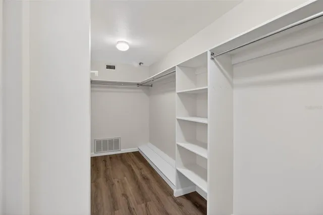 a view of walk in closet with empty racks