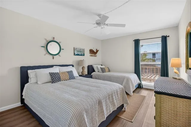 a bedroom with two beds and a window