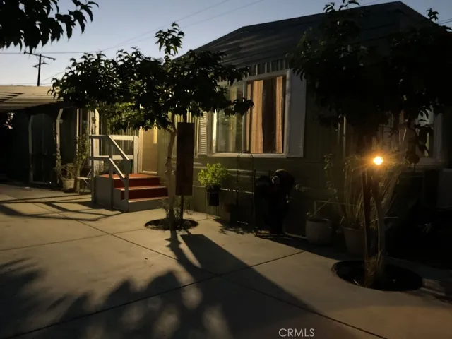 a view of a house with backyard porch and sitting area