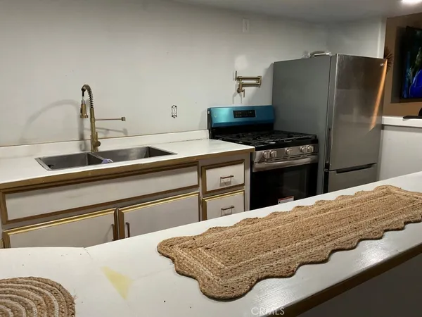 a kitchen with a refrigerator and a sink
