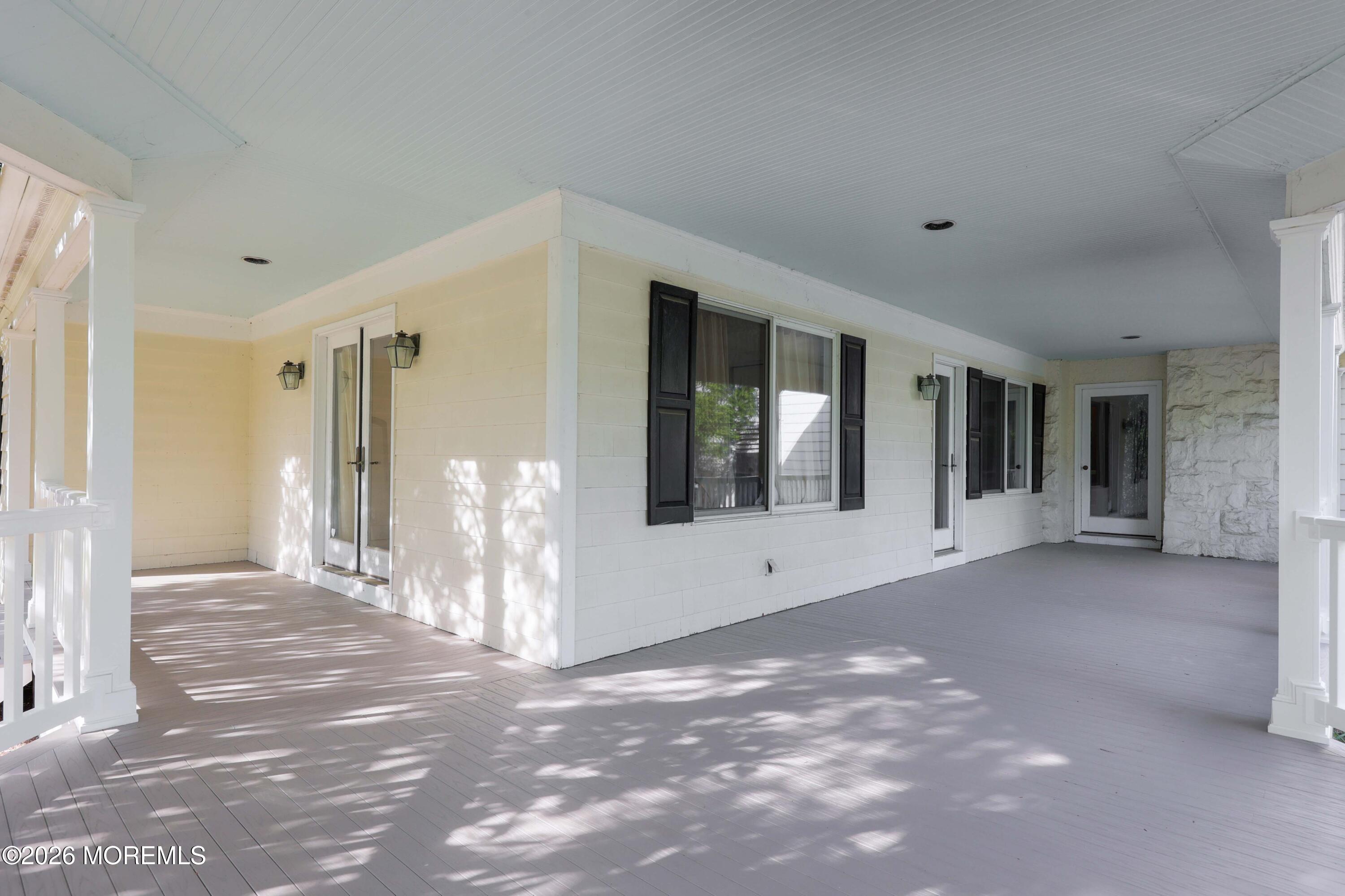 5 Edwards Point Road Rumson, NJ 07760 - Photo 44 of 58 a view of a big room with windows and chandelier