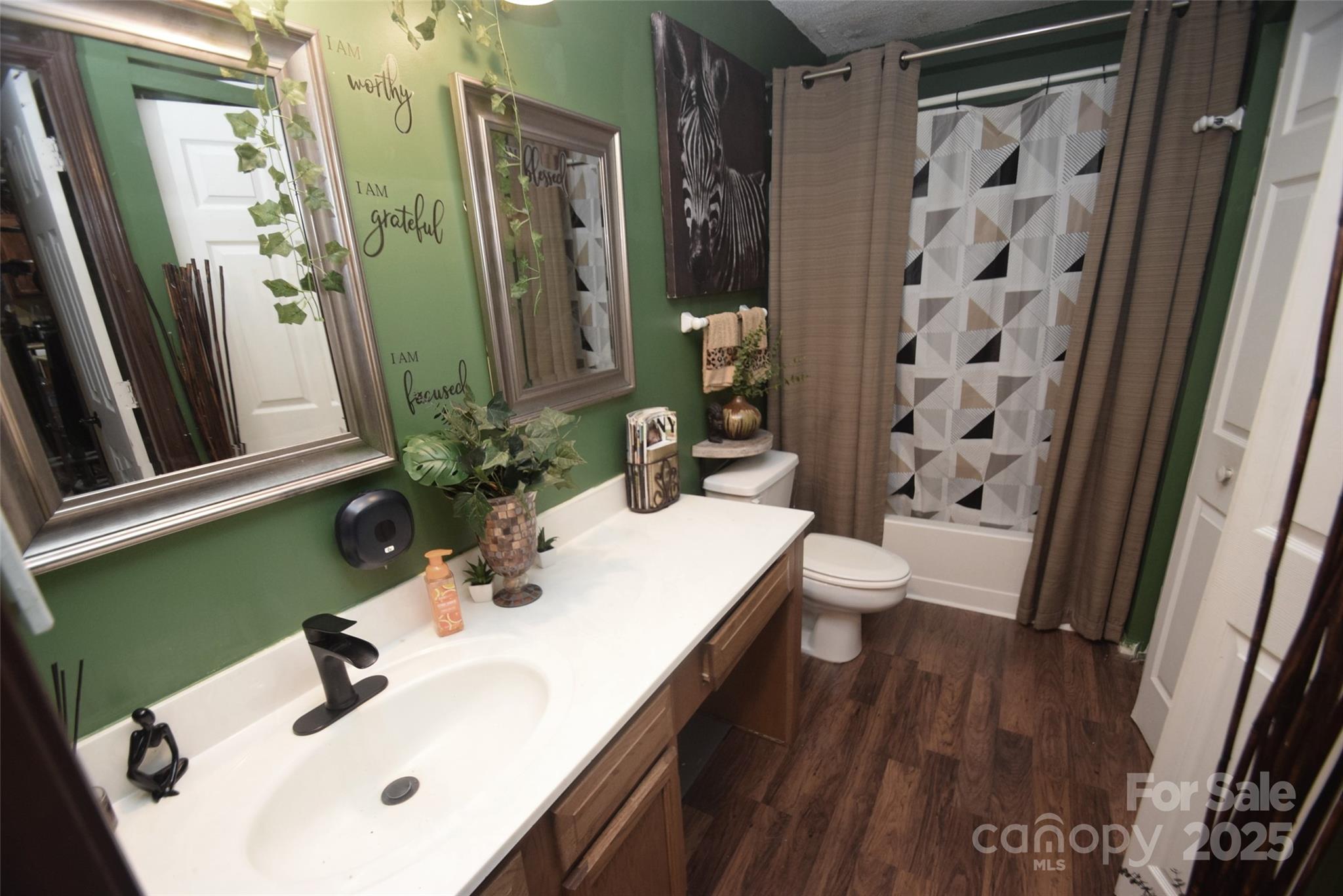 11130 Whitlock Crossing Court Charlotte, NC 28273 - Photo 12 of 27 a bathroom with a sink a toilet and shower a mirror