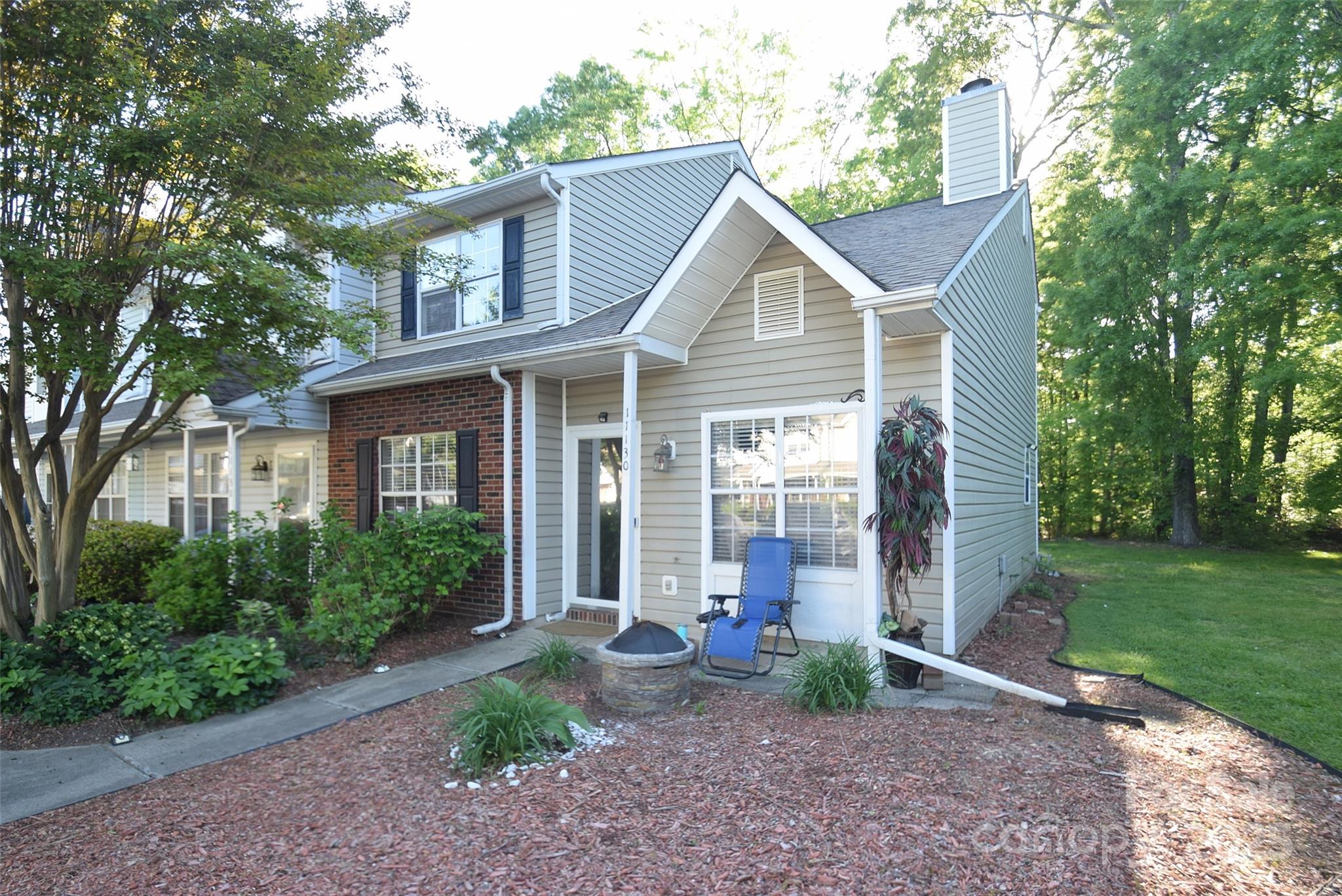 11130 Whitlock Crossing Court Charlotte, NC 28273 - Photo 3 of 27 a view of a white house next to a yard with big trees