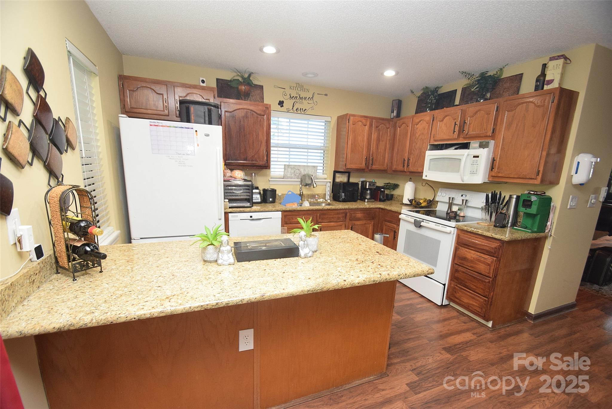 11130 Whitlock Crossing Court Charlotte, NC 28273 - Photo 8 of 27 a kitchen with stainless steel appliances granite countertop a sink dishwasher a refrigerator and a stove with wooden floor