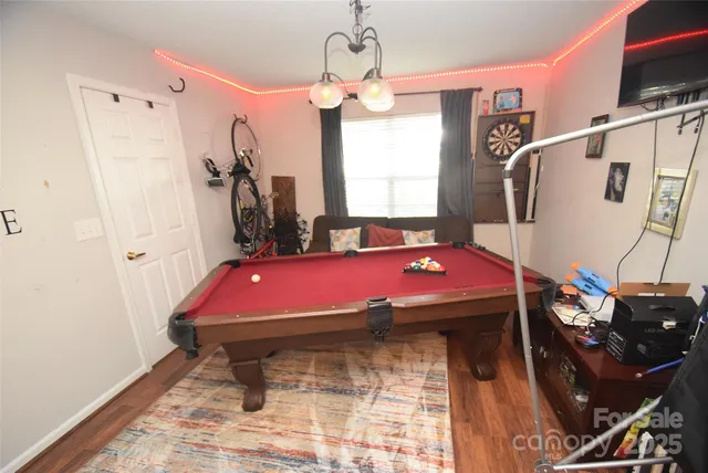 a room with pool table and a window
