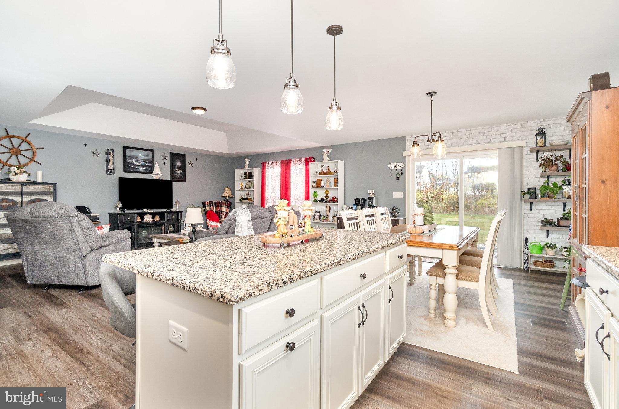 506 Granite Run Carlisle, PA 17015 - Photo 16 of 37 a large kitchen with kitchen island granite countertop a table chairs and a chandelier