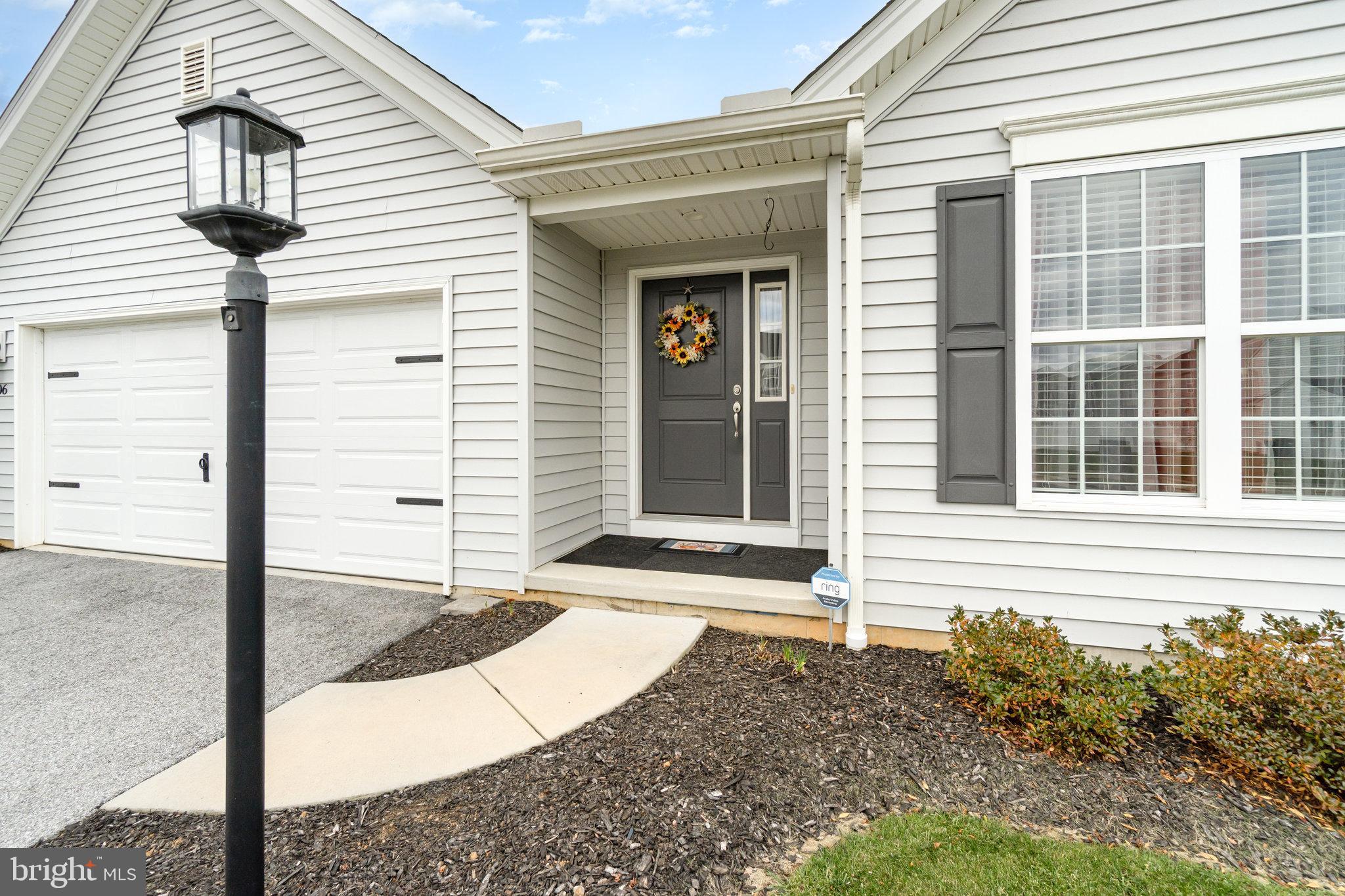 506 Granite Run Carlisle, PA 17015 - Photo 4 of 37 a front view of a house with a yard and garage