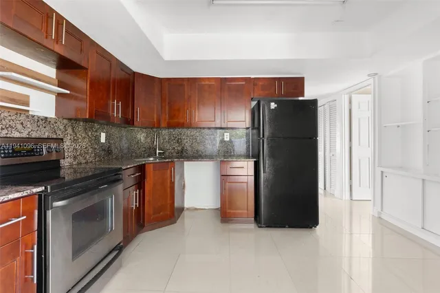 a view of a hallway with wooden floor and a living room