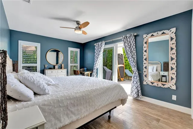 a bedroom with a bed and large window with outer view