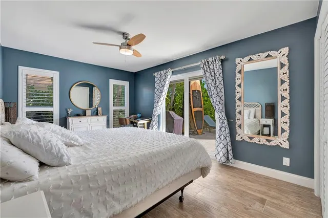 a bathroom with a granite countertop sink a toilet a mirror and shower