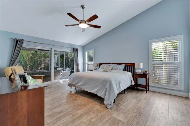a bedroom with a large bed and a flat tv screen on dresser