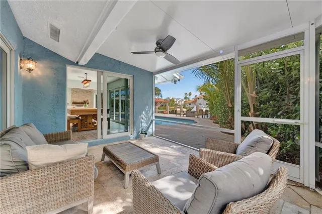 a room with pool table and large windows