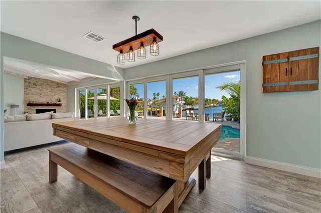 a dining hall with stainless steel appliances kitchen island granite countertop a stove and a sink