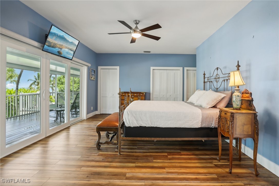 8335 Main Street Bokeelia, FL 33922 - Photo 31 of 47 a bedroom with a bed and wooden floor