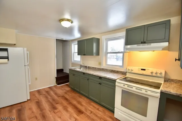 a kitchen with a stove a sink and a refrigerator