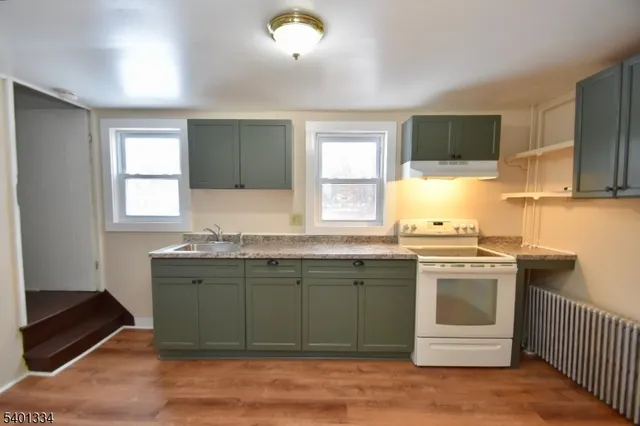 a kitchen with a sink stove and cabinets