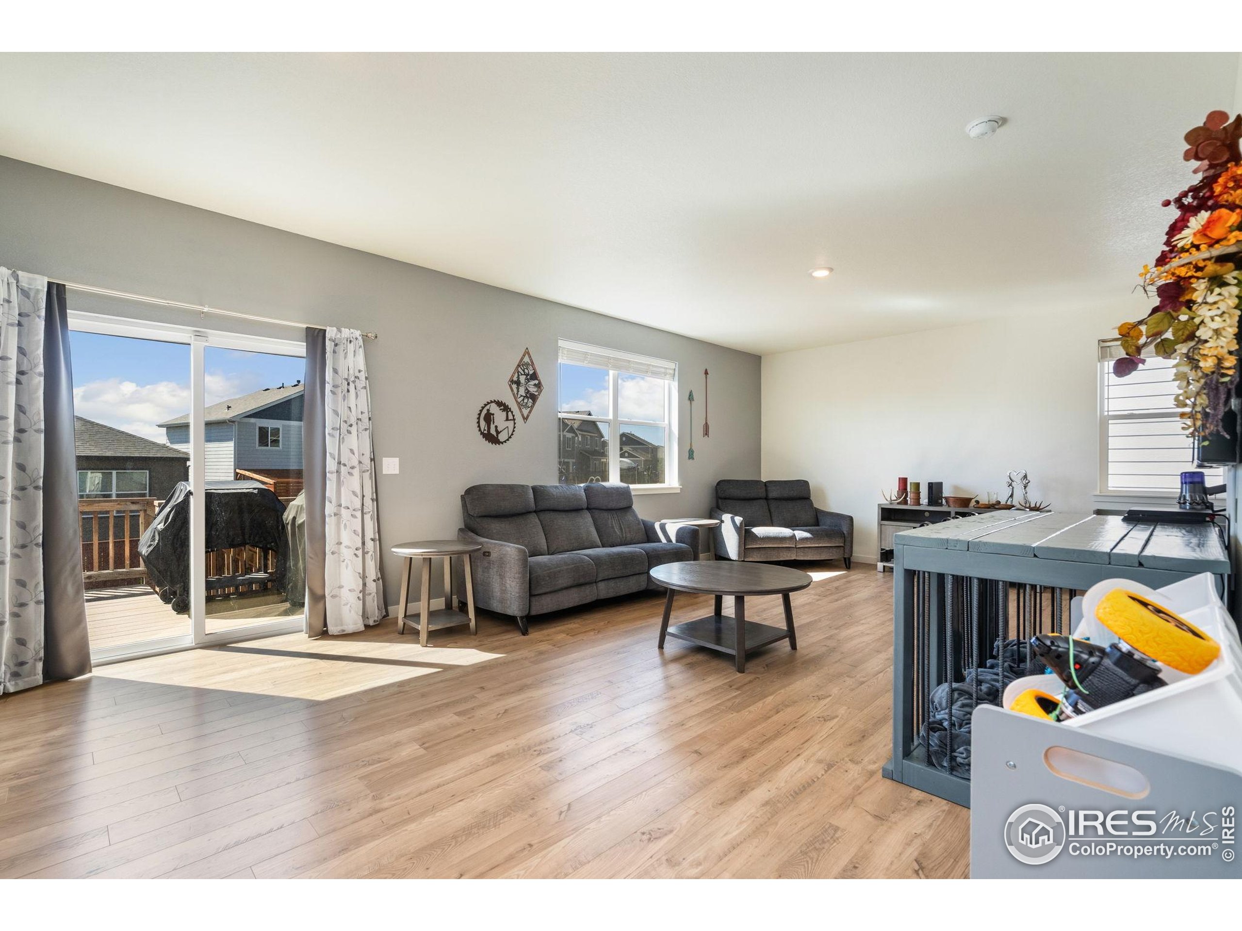 1233 Lily Mountain Road Severance, CO 80550 - Photo 15 of 44 a living room with furniture and a wooden floor