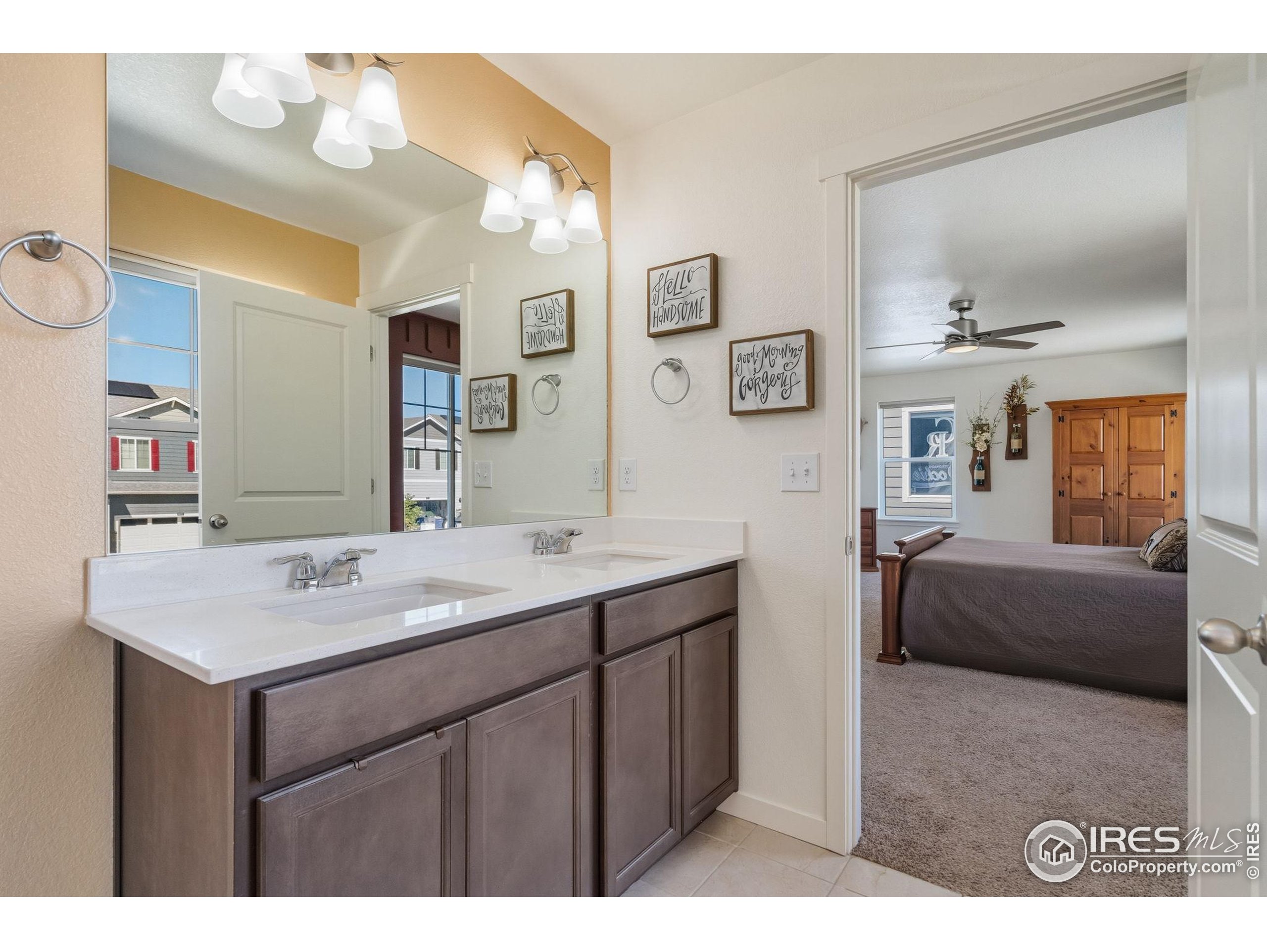 1233 Lily Mountain Road Severance, CO 80550 - Photo 24 of 44 a en suite bathroom with a sink double vanity and a mirror
