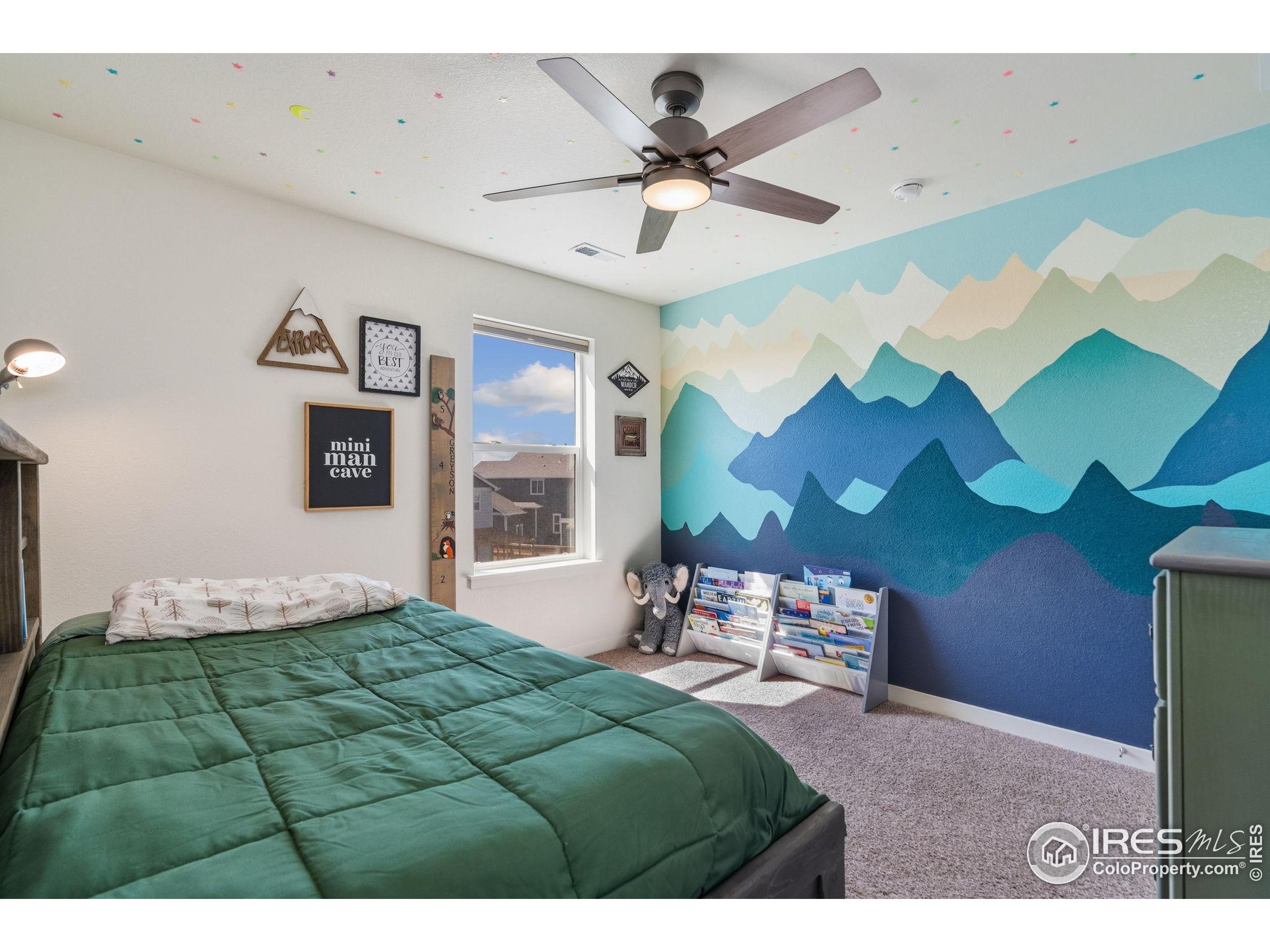 1233 Lily Mountain Road Severance, CO 80550 - Photo 26 of 44 a bed room with a bed and a chandelier