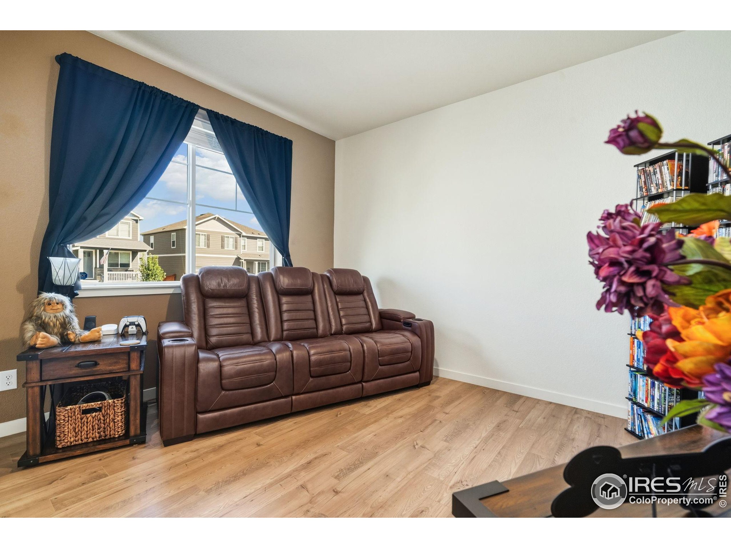 1233 Lily Mountain Road Severance, CO 80550 - Photo 7 of 44 a living room with furniture a window and a wooden floor