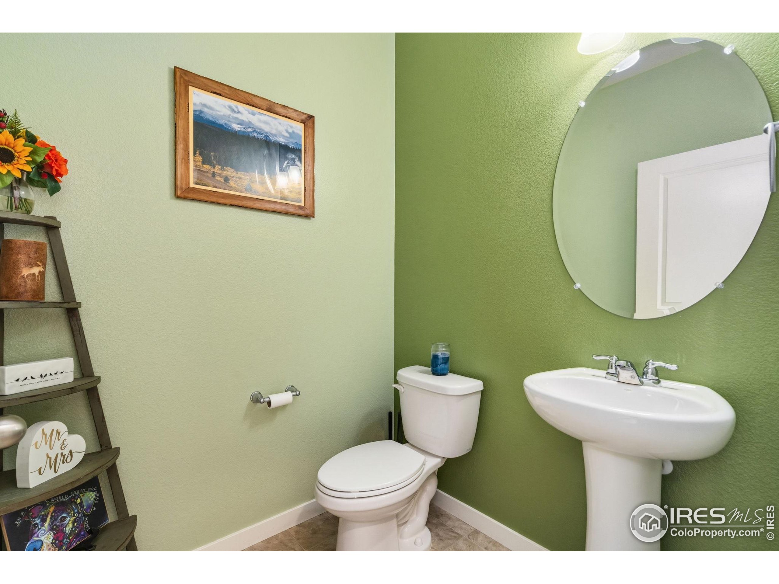 1233 Lily Mountain Road Severance, CO 80550 - Photo 8 of 44 a bathroom with a toilet sink and mirror