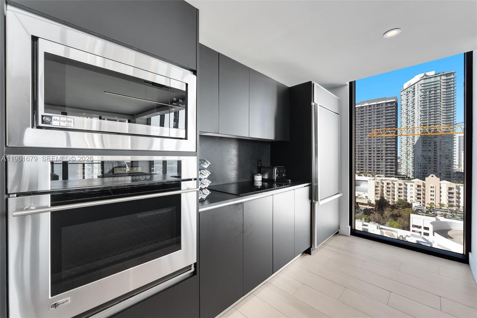 460 Northeast 28th Street, Unit 1601 Miami, FL 33137 - Photo 11 of 41 a kitchen with stainless steel appliances and cabinets
