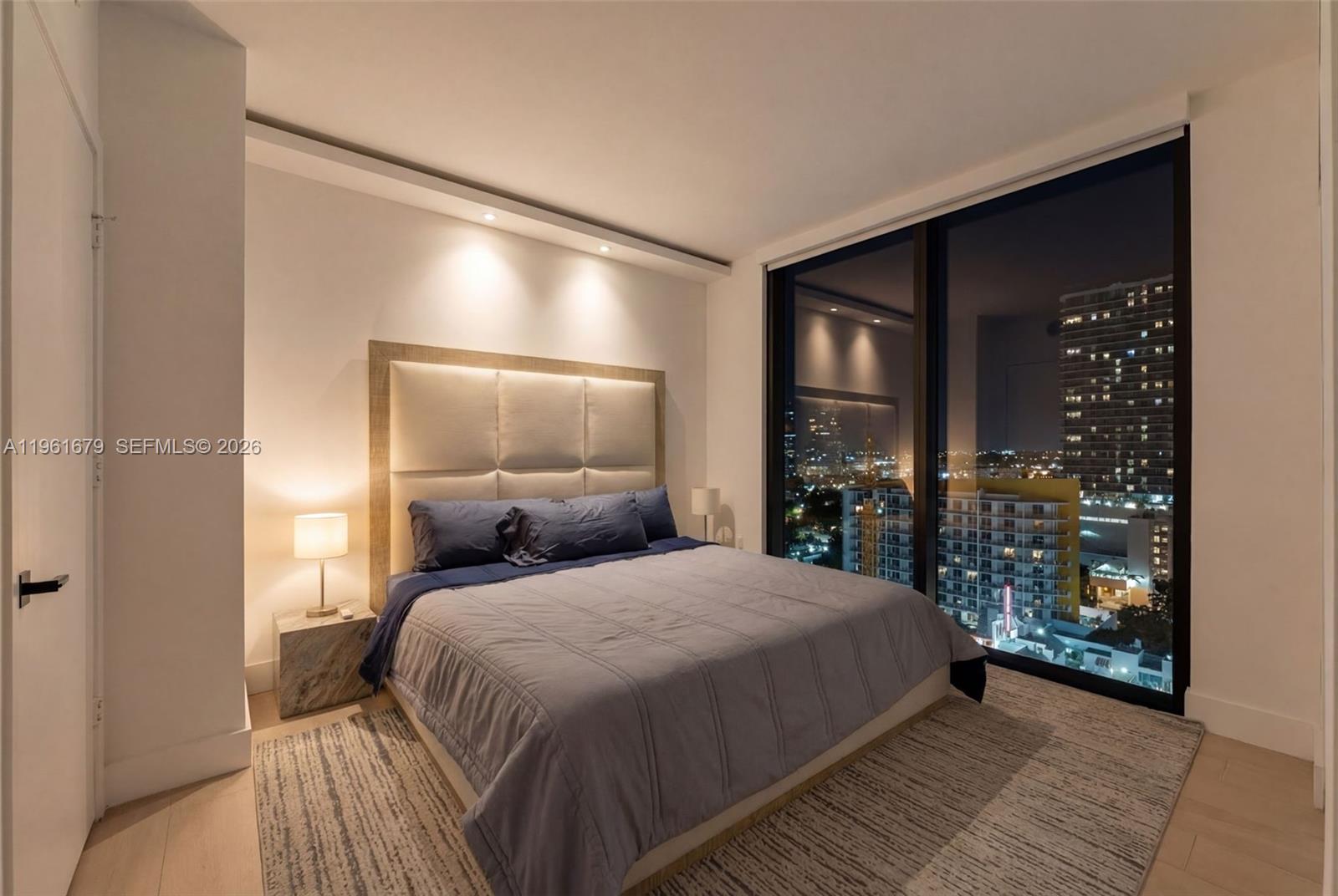 460 Northeast 28th Street, Unit 1601 Miami, FL 33137 - Photo 15 of 41 a bedroom with a large bed and a window