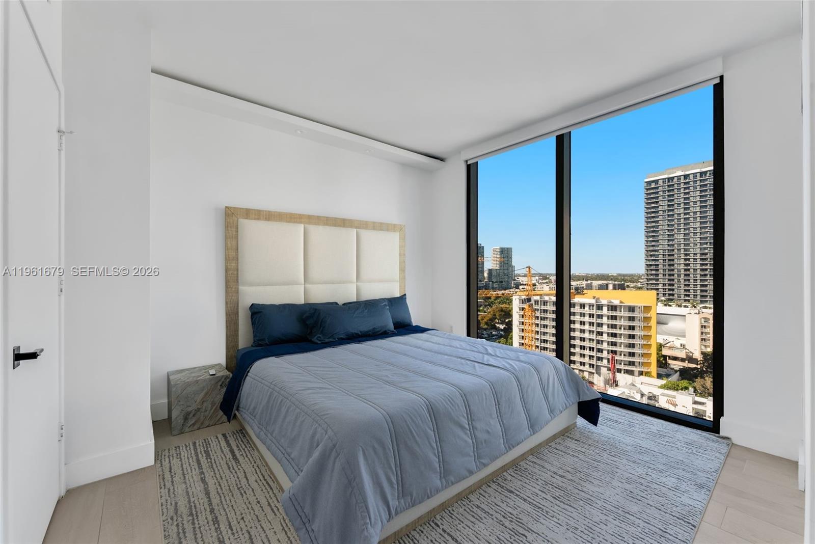 460 Northeast 28th Street, Unit 1601 Miami, FL 33137 - Photo 16 of 41 a bedroom with a large bed and a large window