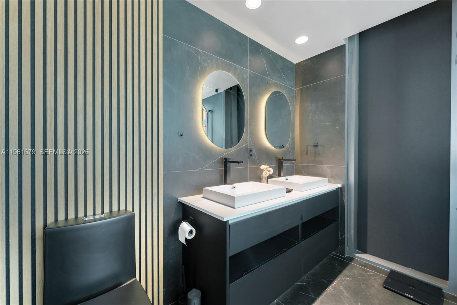 460 Northeast 28th Street, Unit 1601 Miami, FL 33137 - Photo 19 of 41 a bathroom with a sink and a mirror