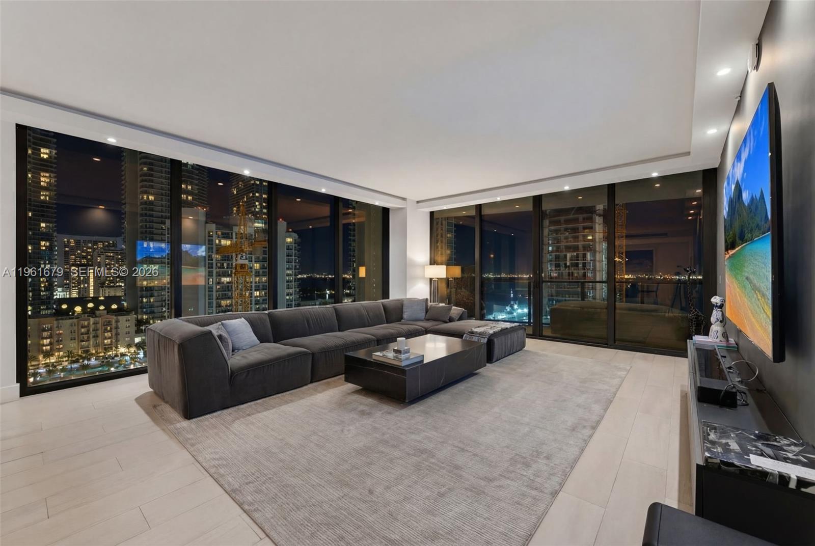 460 Northeast 28th Street, Unit 1601 Miami, FL 33137 - Photo 2 of 41 a living room with furniture window and flat screen tv