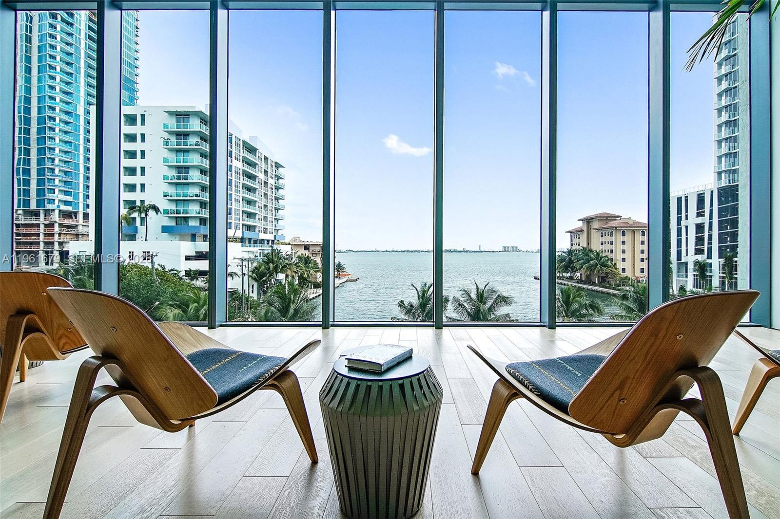 460 Northeast 28th Street, Unit 1601 Miami, FL 33137 - Photo 24 of 41 a balcony view with a couple of chairs and a potted plant