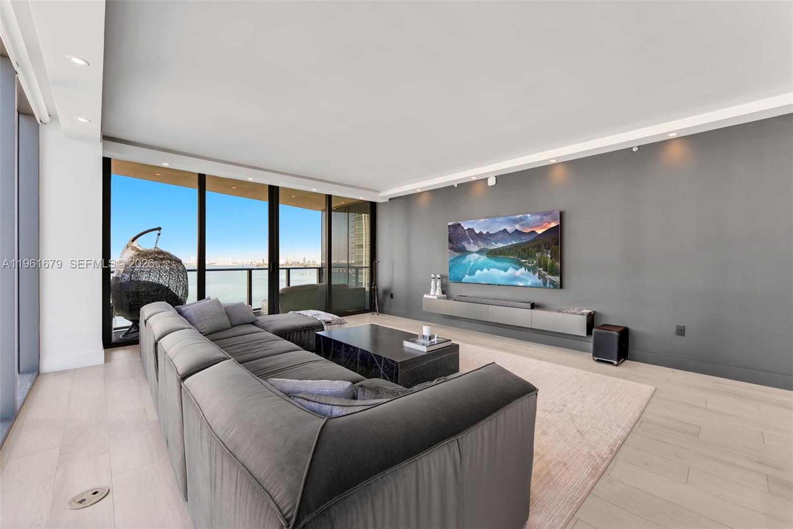 460 Northeast 28th Street, Unit 1601 Miami, FL 33137 - Photo 3 of 41 a living room with furniture and a flat screen tv