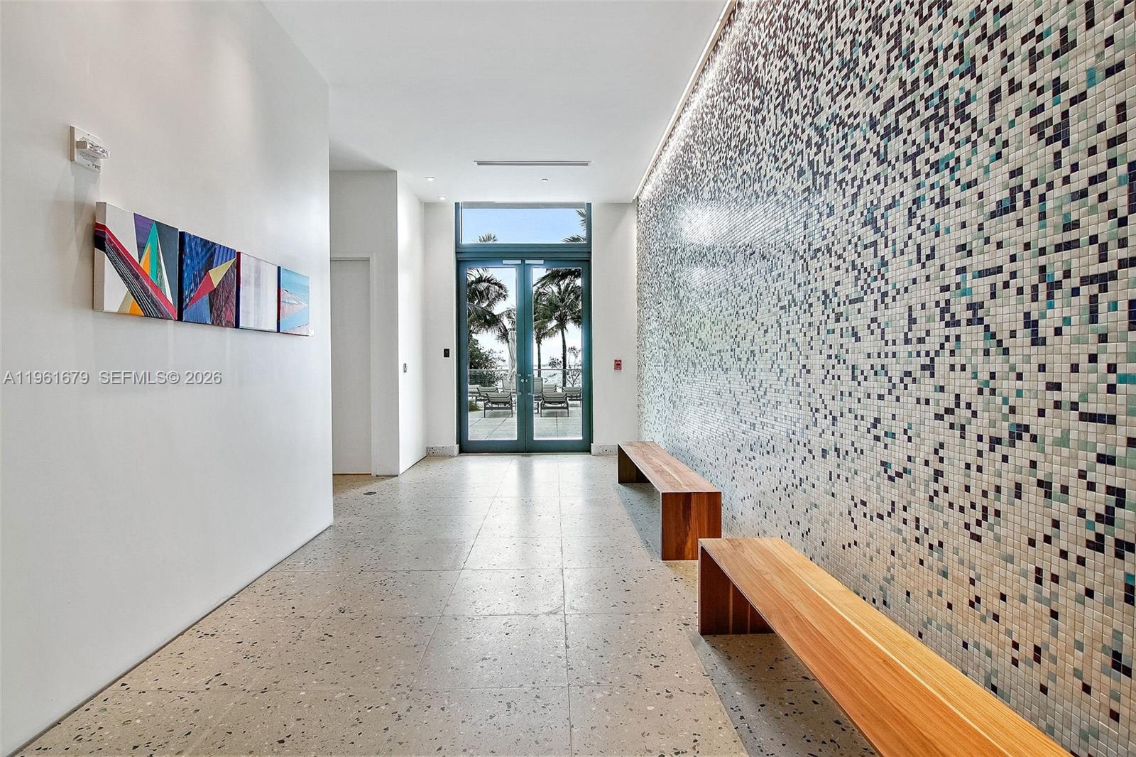 460 Northeast 28th Street, Unit 1601 Miami, FL 33137 - Photo 34 of 41 a hallway with a bench in it