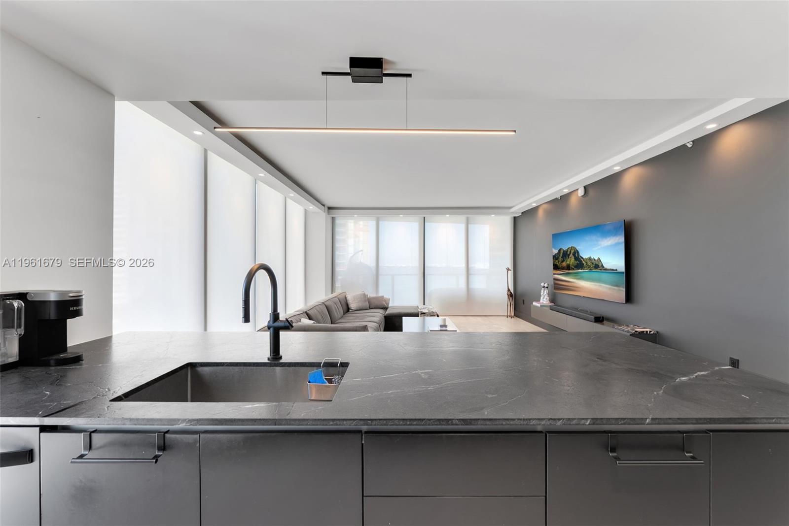 460 Northeast 28th Street, Unit 1601 Miami, FL 33137 - Photo 9 of 41 a kitchen with kitchen island a sink appliances and a counter top space