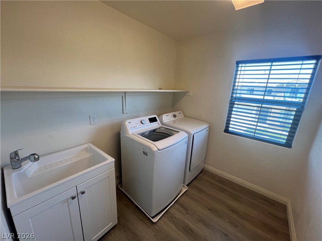 9581 Aberdeen Ridge Court Las Vegas, NV 89148 - Photo 16 of 25 A dedicated utility space features a convenient laundry sink, ample shelving, and durable flooring.