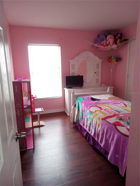 10933 Subtle Trail Drive Riverview, FL 33579 - Photo 17 of 22 a bedroom with a bed and a chandelier