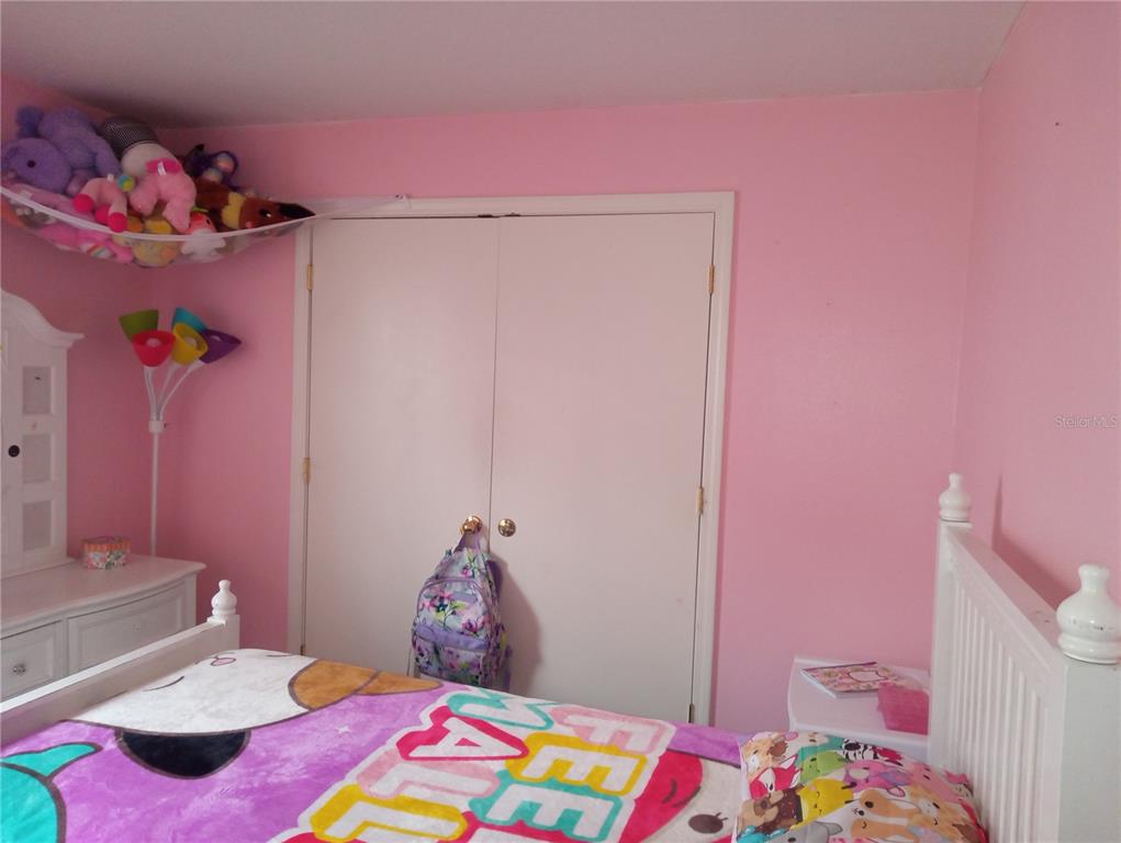 10933 Subtle Trail Drive Riverview, FL 33579 - Photo 18 of 22 a bedroom with a bed and a window