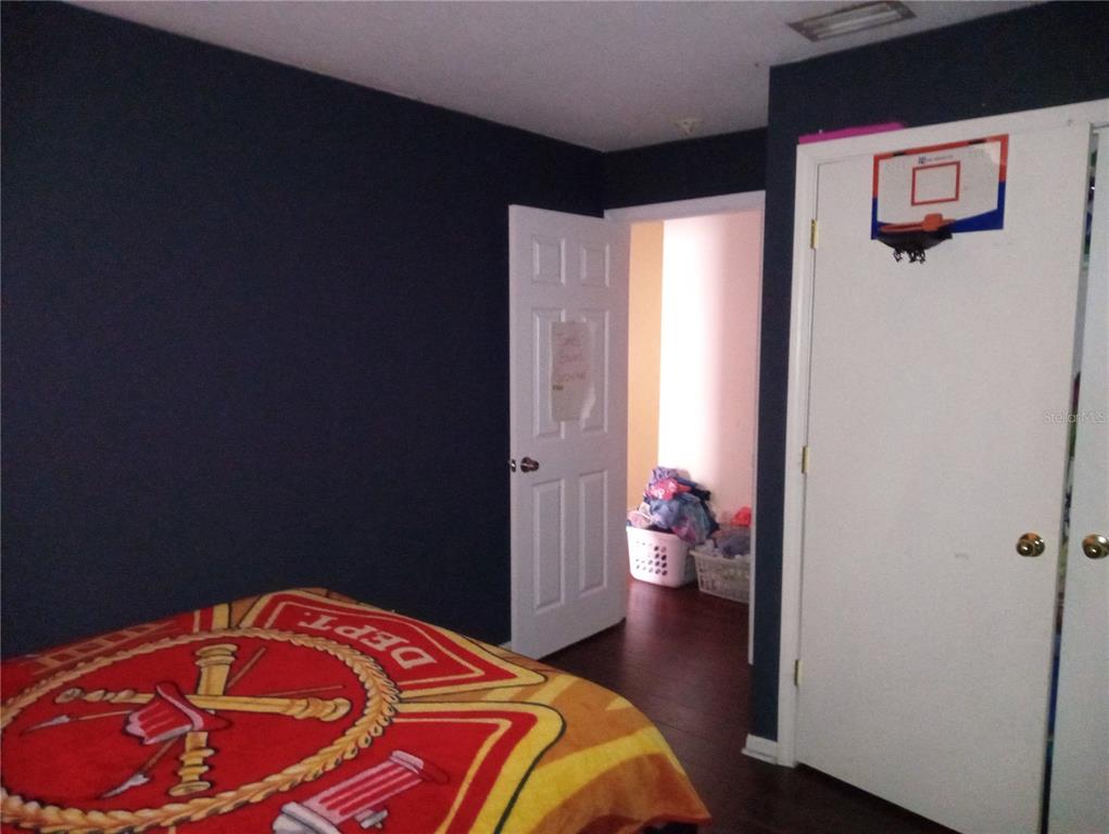 10933 Subtle Trail Drive Riverview, FL 33579 - Photo 20 of 22 a bedroom with a bed and wooden floor