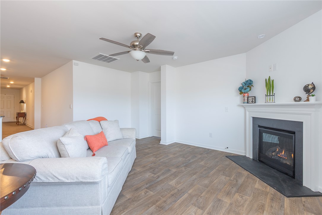 231 Millhone Way Pendleton, SC 29670 - Photo 15 of 32 This bright living room features durable flooring and a cozy fireplace, creating an inviting atmosphere.
