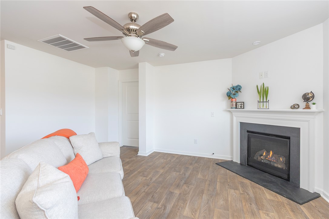 231 Millhone Way Pendleton, SC 29670 - Photo 16 of 32 Warm and inviting living area features a fireplace, ceiling fan, and durable wood flooring.